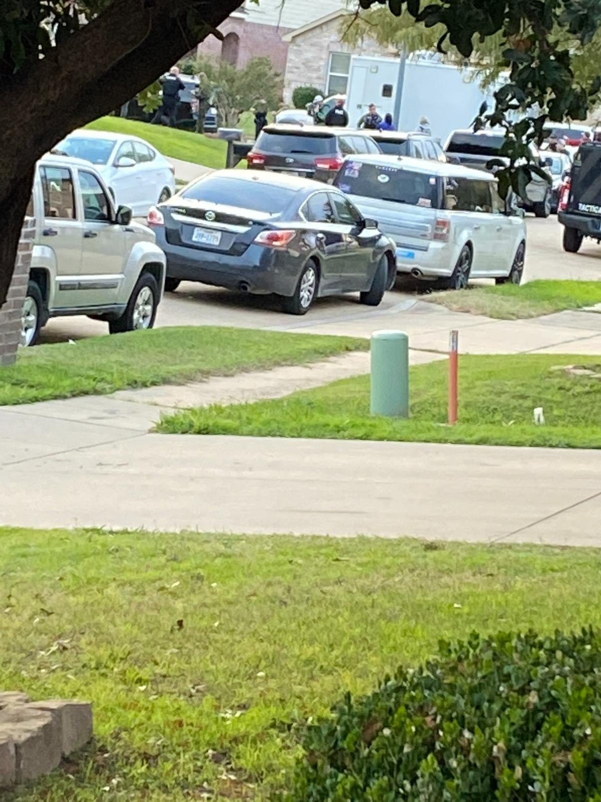 Police fill the street where a suspect accused of shooting a sheriff’s deputy was arrested in Fort Worth on Monday, Nov. 27, 2023.