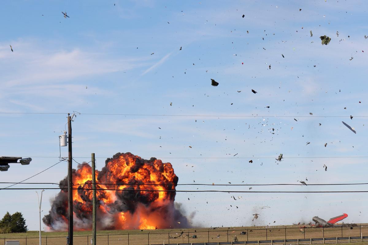 In this photo provided by Nathaniel Ross Photography, a historic military plane crashes after colliding with another plane during an airshow at Dallas Executive Airport on Saturday, Nov. 12, 2022. (Nathaniel Ross Photography via AP)