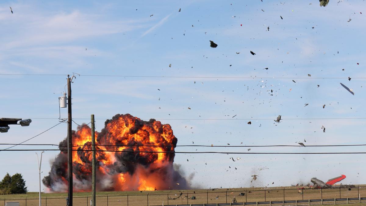 In this photo provided by Nathaniel Ross Photography, a historic military plane crashes after colliding with another plane during an air show at Dallas Executive Airport in Dallas on Saturday, Nov. 12, 2022. (Nathaniel Ross Photography via AP)