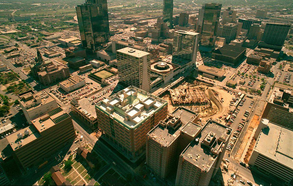 April 1990: Aerial of downtown Fort Worth, looking northeast, showing construction of the Tandy building expansion, which today is the Tarrant County Plaza Building. The jail and courts buildings are in the foreground.