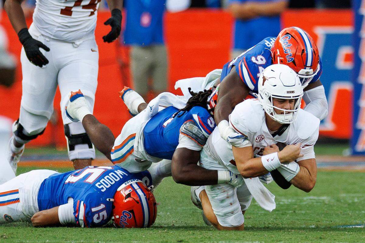 Oct 4, 2025; Gainesville, Florida, USA; Florida Gators defensive end Tyreak Sapp (94) and linebacker Myles Graham (5) sack Texas Longhorns quarterback Arch Manning (16) during the second half at Ben Hill Griffin Stadium. Mandatory Credit: Matt Pendleton-Imagn Images