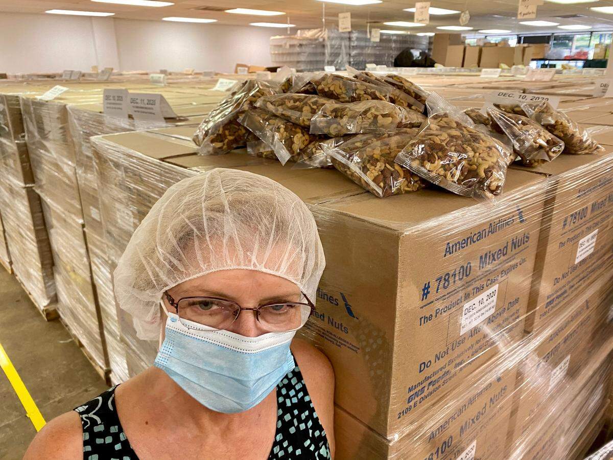 Kim Peacock of GNS Foods in Arlington is stuck with thousands of pounds of mixed nuts.
