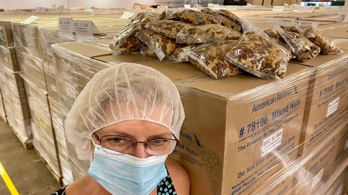 Kim Peacock of GNS Foods in Arlington is stuck with thousands of pounds of mixed nuts.