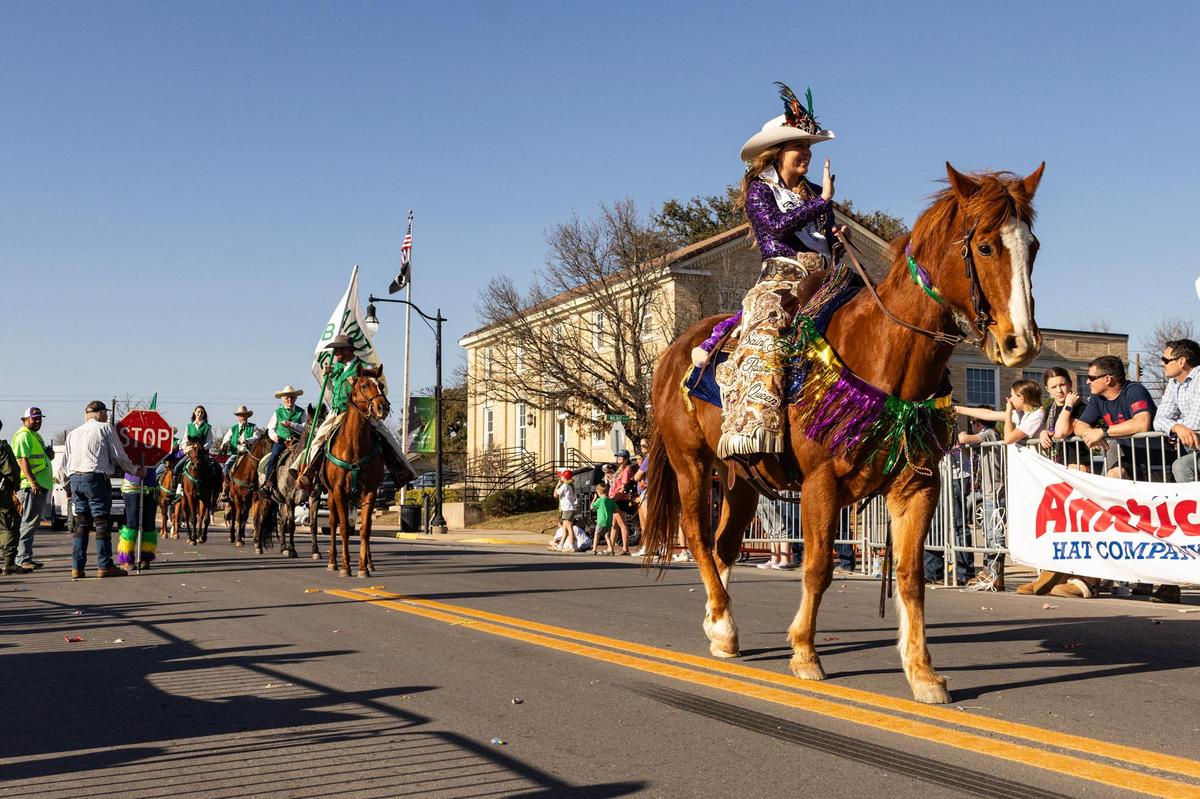 Rylie Berend, the Saint Jo Rodeo Queen, rides on her horse in front of the Saint Jo Riding Club during the parade for the 15th Annual Mardi Gras Nocona Style on Clay Street in Nocona on Saturday, Mar. 1, 2025.