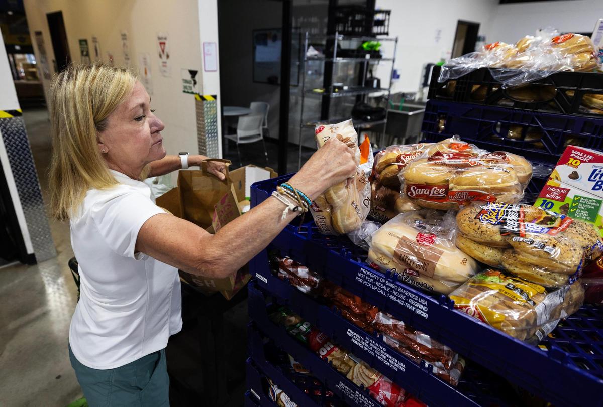 Pauline Hartley, a volunteer with Community Link for over a year, gathers groceries for clients of the food pantry on Tuesday, July 22, 2025. The pantry provides about two weeks of food per pickup.