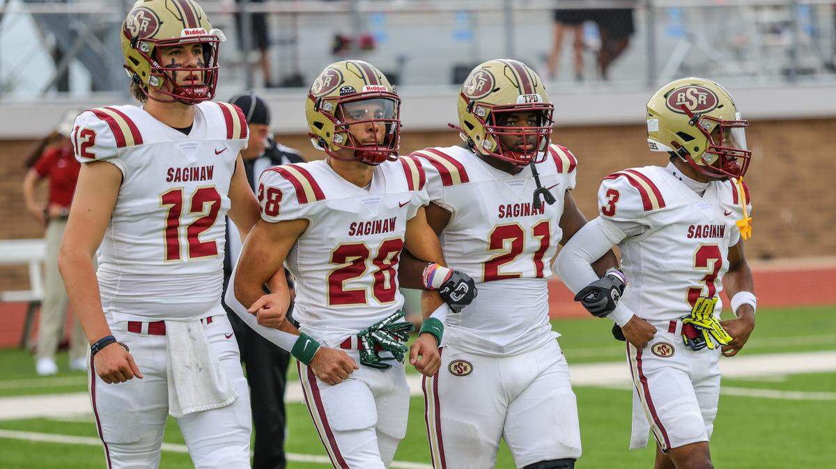 The Saginaw captains walk out for the coin flip at Boswell Pioneer Stadium on Friday, Sept. 5, 2025.