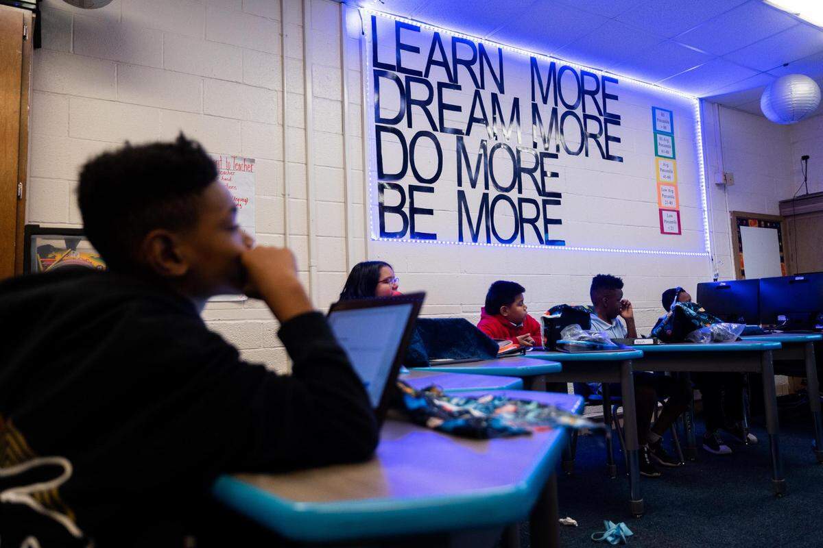 Students listen to their teacher, Austin Grant, in fourth-grade math at the Leadership Academy at Mitchell Boulevard Elementary.
