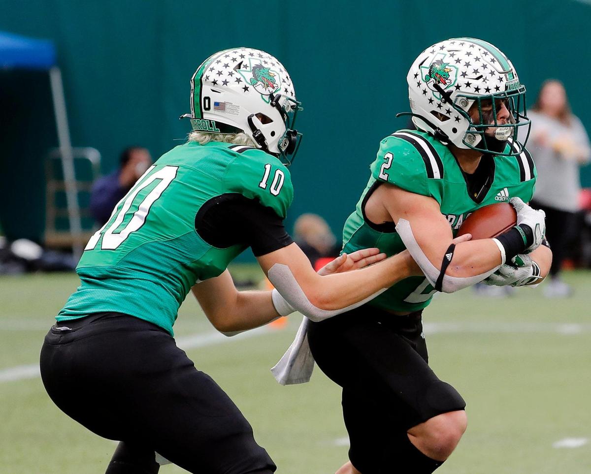 Southlake Carroll quarterback Graham Knowles (10) hands off to running back Owen Allen (2) in the first half of Class 6A D2 regional semi-finals football game at Choctaw Stadium in Arlington, Texas, Friday, Nov. 25, 2022. Carroll tied the game at 7 with 28.6 seconds remaining in the half but McKinney stormed back in 21 seconds and made the game 14-7. (Special to the Star-Telegram Bob Booth)