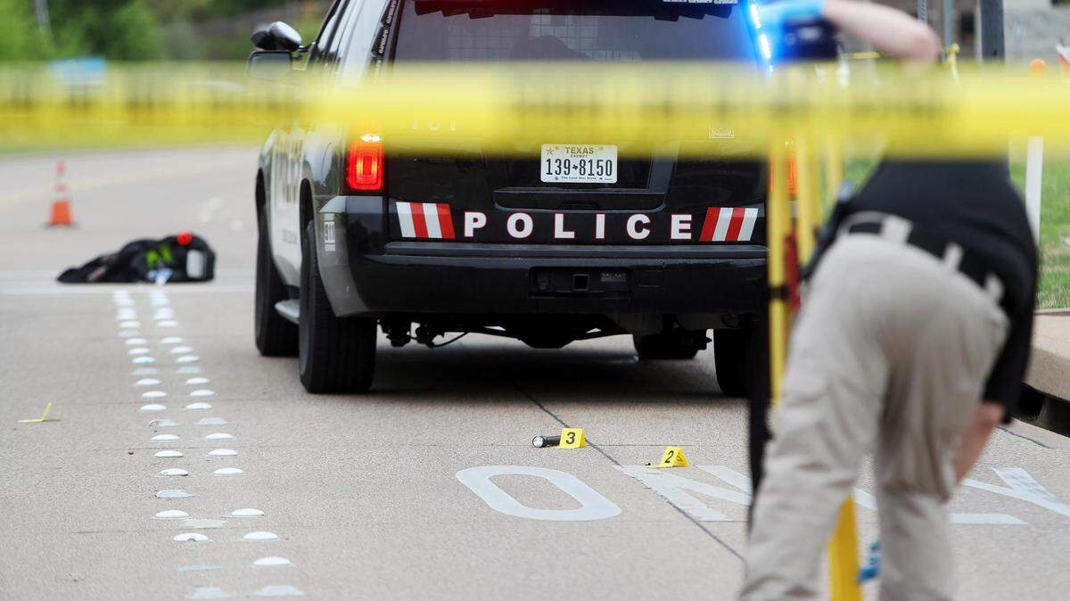 Members of the Burleson Police Department investigate the area where a police officer was shot in the 1100 block of SW Hillside Drive on Wednesday, April 14, 2021. A Burleson police officer was shot multiple times during a traffic stop and is in stable condition.