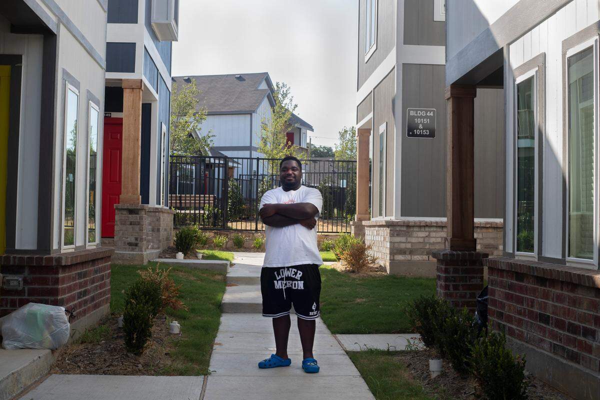 Kendri Burnett stands for a portrait outside of his home at the Cottages at Bell Station in Hurst, Texas, on July 5, 2022.