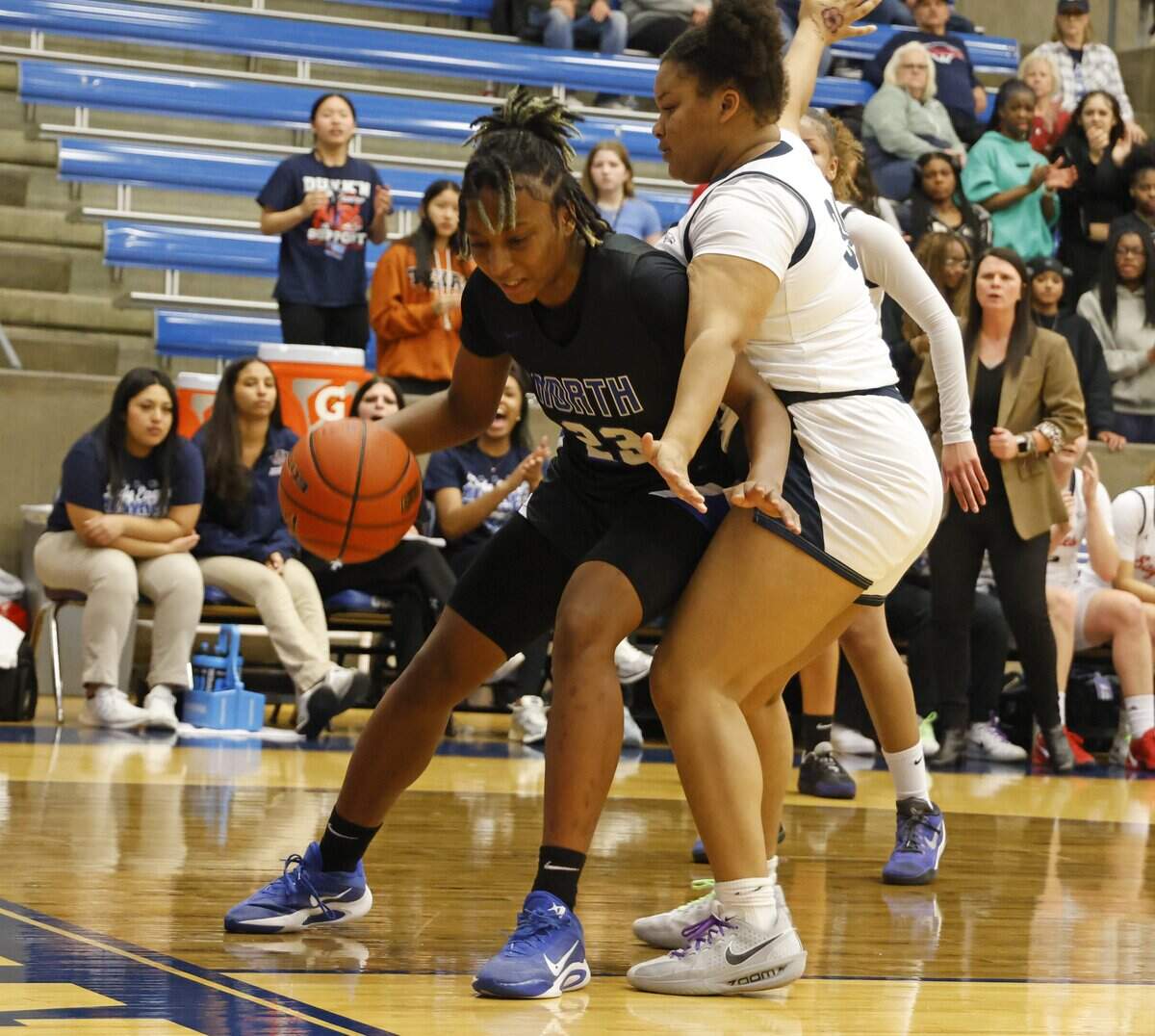 Allen forward Ashley Gatson (34) rides North Crowley forward Mecca Crawford (23) to the baseline during the first half of a UIL Class 6A Division I girls regional semifinals basketball playoff game at Grand Prairie High School in Grand Prairie, Texas, Tuesday Feb. 24, 2026.