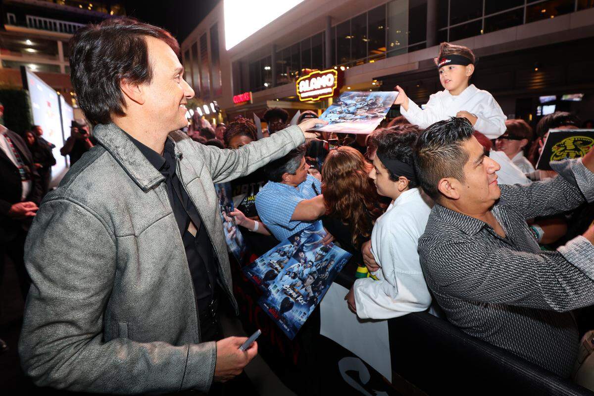IRVING, TEXAS - NOVEMBER 13: Ralph Macchio signs autographs for fans at the COBRA KAI Dallas Red Carpet Fan Screening at Alamo Drafthouse Cinema Las Colinas on November 13, 2024 in Irving, Texas.