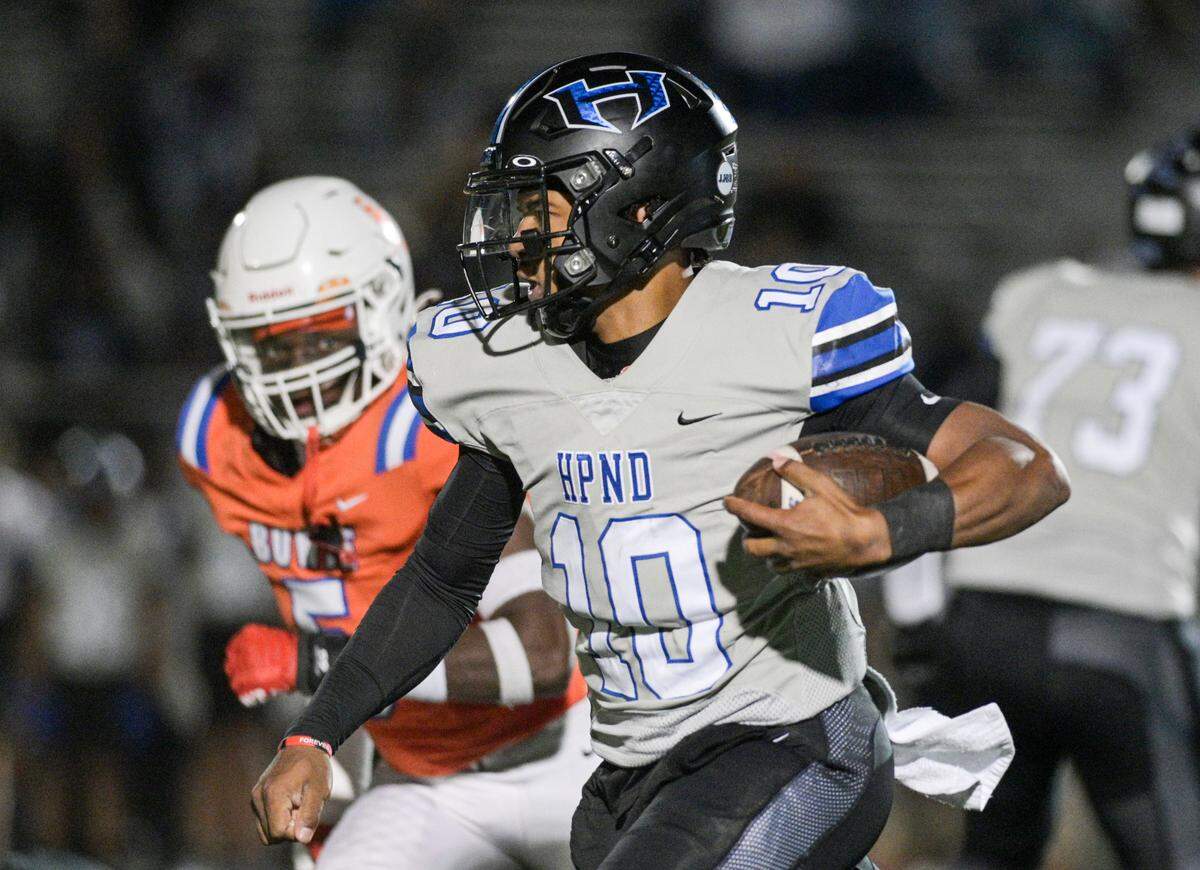 Hebron Hawk quarterback Patrick Crayton Jr.(10) runs down the field during a UIL football playoff game against Bowie High School at Mustang-Panther Stadium in Grapevine, Texas on Friday, Nov. 22, 2024.