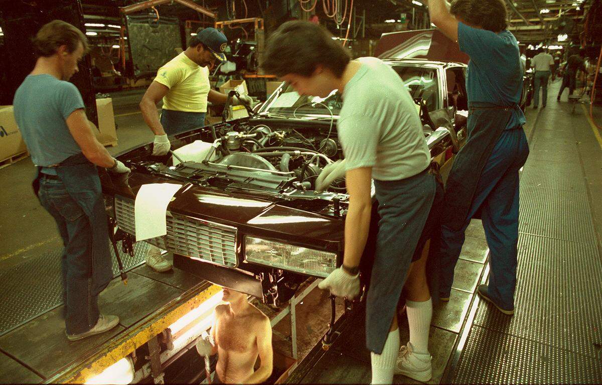 April 3, 1986: General Motors Arlington Assembly employees work on a 1986 Chevrolet Monte Carlo.