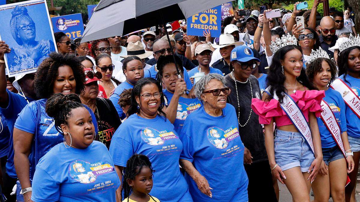 Opal Lee, center, walks through Fair Park with her granddaughter Dione Sims, third from left, and hundreds of participants during 2024 Opal’s Walk for Freedom honoring the Juneteenth U.S. federal holiday in Dallas.