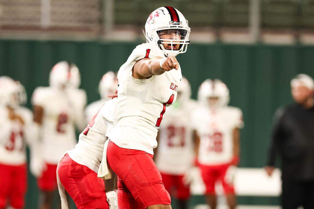 Burleson quarterback Andrew Sparks changes signals with his wide receiver before a snap in a district game between Arlington Seguin and Burleson at Choctaw Stadium in Arlington, Texas on Sept. 11, 2025.