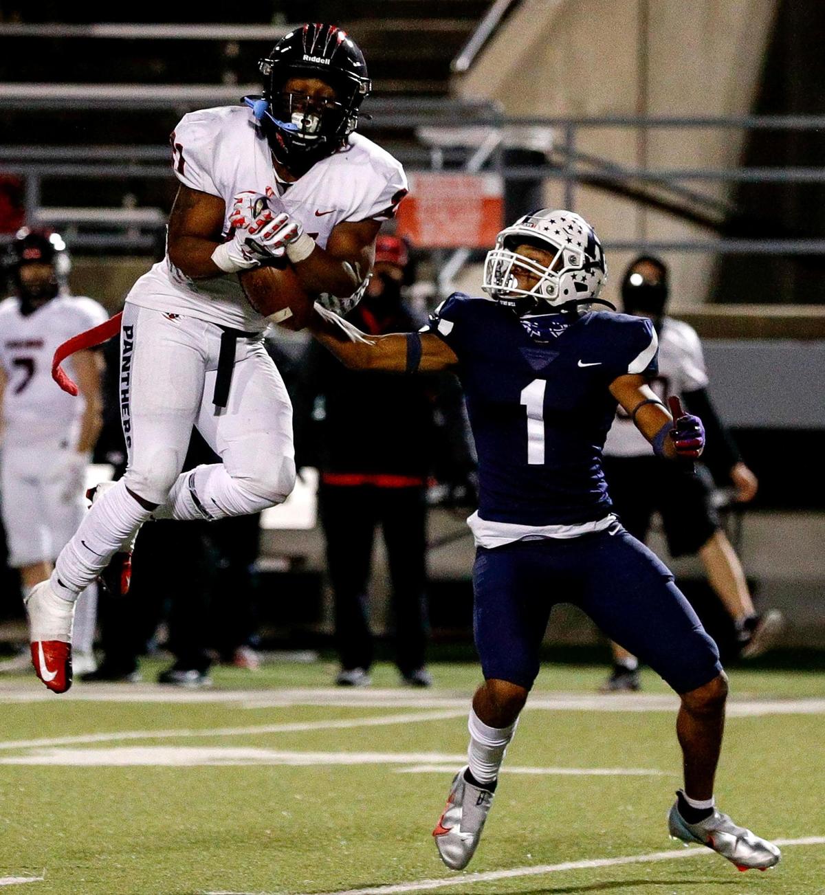 Colleyville Heritage defensive back BJ Roney (21) steps in front of Richland receiver CJ Nelson (1) for an interception during the second half of a high school football game, October 23, 2020 played at the Birdville ISD Fine Arts/Athletics Complex in North Richland Hills, Tx. (Steve Nurenberg Special to the Star-Telegram)