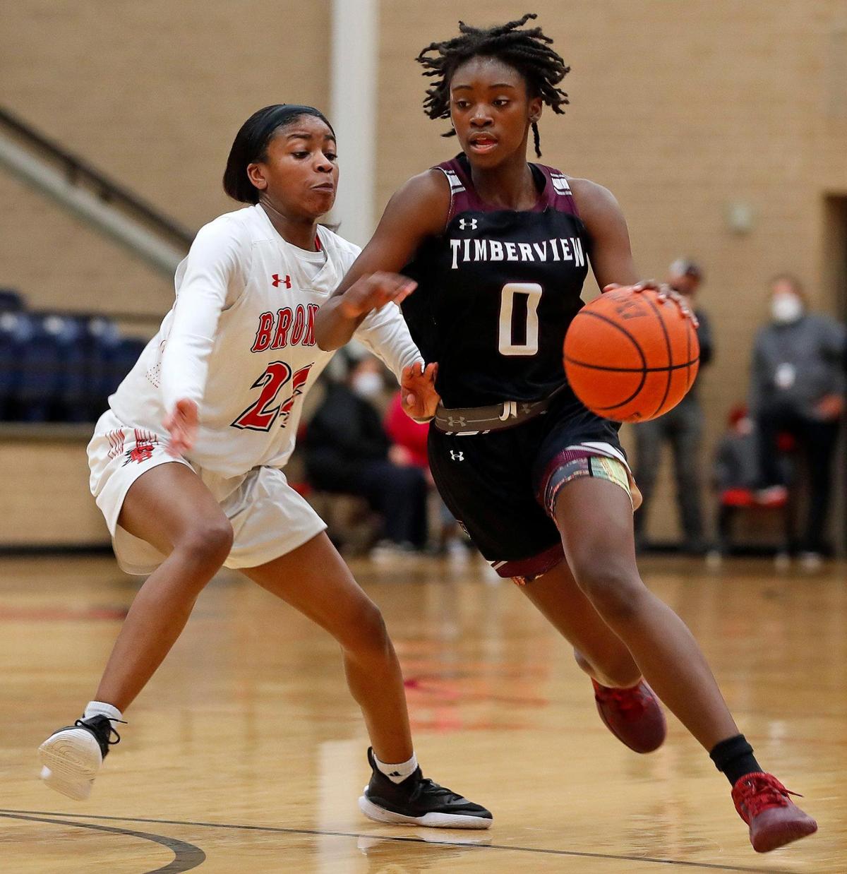 Timberview guard Stephanie Mosley (0) crosses mid-court in front of Legacy guard Eryn Scott (24) in the second half of a 8-5A district high school girls basketball game at Legacy High School in Mansfield, Texas, Friday, Jan. 22, 2021. Legacy defeated Timberview 46-21. (Special to the Star-Telegram Bob Booth)