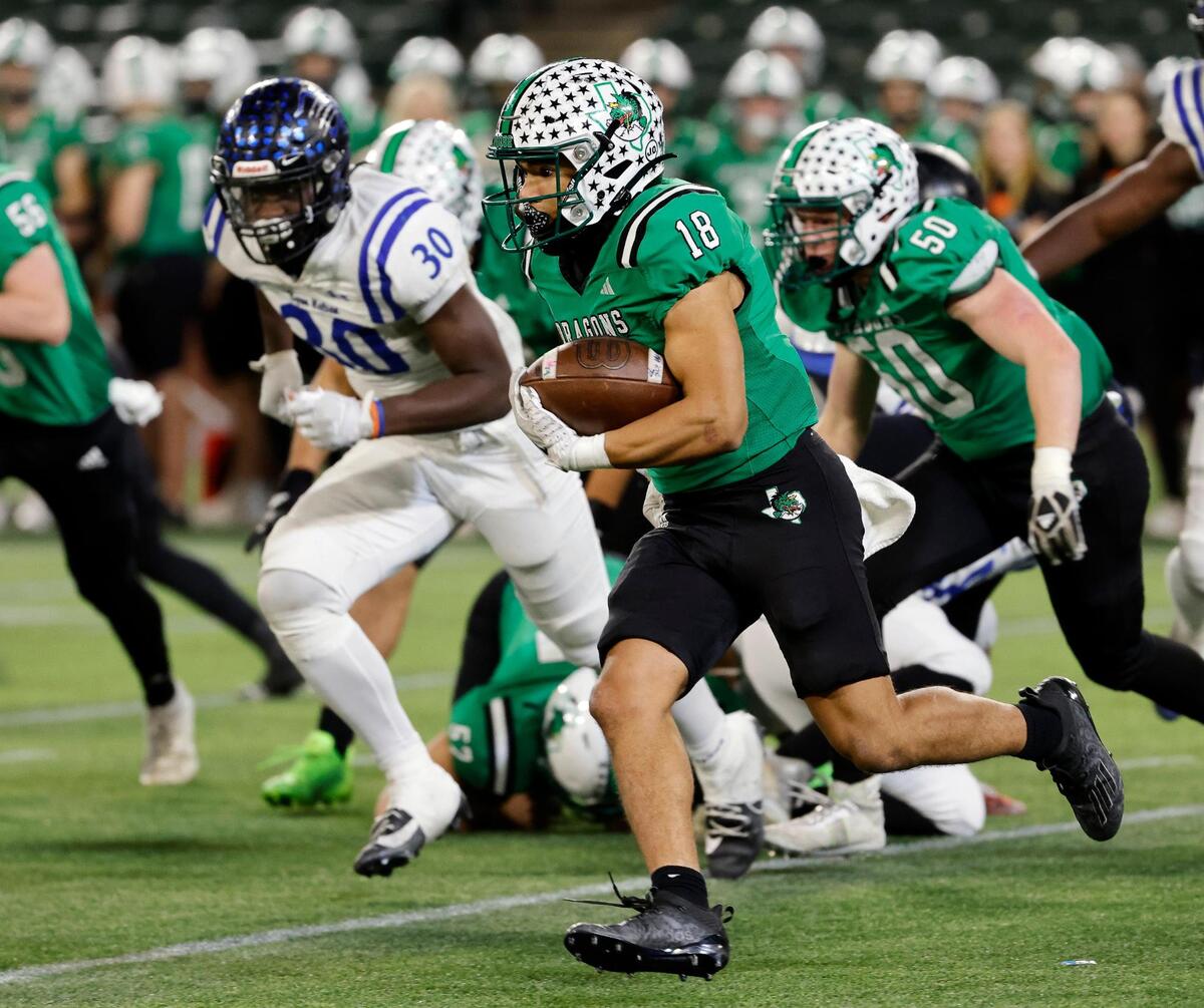 Carroll running back Christian Glenn (18) brings the ball around the left side during the second half of a UIL Conference 6A Division 2 quarterfinal football playoff game at Choctaw Stadium in Arlington, Texas, Saturday, Dec. 02, 2023.
