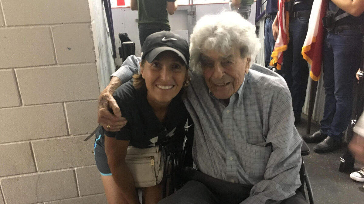 Anna Salton Eisen, left, visits with decorated veteran James Megellas in 2018 at a fundraiser for veterans in North Richland Hills. Megellas, who died in 2020 at age 103, will be laid to rest Friday at Arlington National Cemetery.