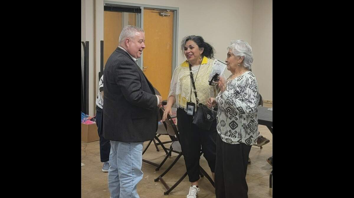 Rick Herring, left, a Fort Worth city council candidate talking with two voters (right).