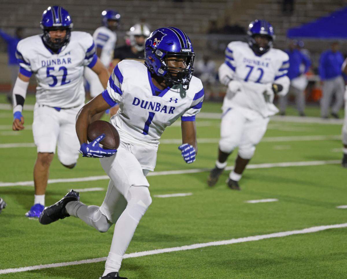 Dunbar wide receiver Detrick James (1) leads the team downfield for a touchdown during the first half of a UIL football game between Benbrook and Dunbar at Herman E. Clark Stadium in Fort Worth, Texas, Friday, October 10, 2025.