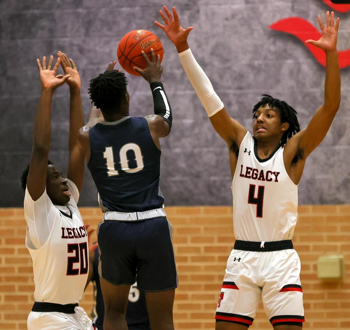 Richland guard Jayden Rhinehart (10) attempts shot against Mansfield Legacy guard John Muhammad (4) and guard Micah Juiye (20) during the first half of a 5A Region 1 Boys Basketball Area-Round 2 playoff game played on February 24, 2021 at Burleson High School. (Steve Nurenberg Special to the Star-Telegram)