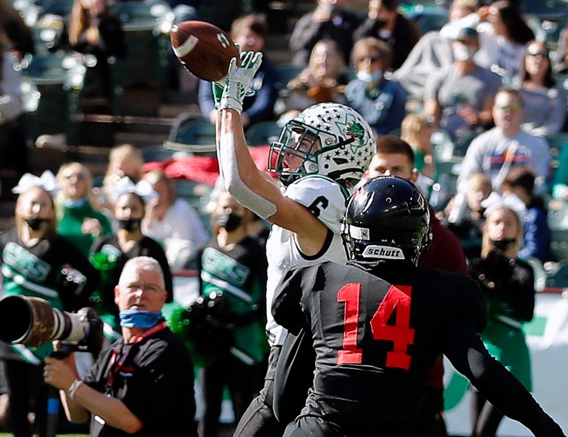 Southlake’s Landon Samson grabs a touchdown pass in front of Trinity defensive back Jaylen Bell (14) to put the Dragons up 44--21 during the 6A division 1 quarterfinals at Globe Life Park in Arlington, Texas, Saturday, Jan. 02, 2021. Southlake defeated Trinity 59-35. (Special to the Star-Telegram Bob Booth)