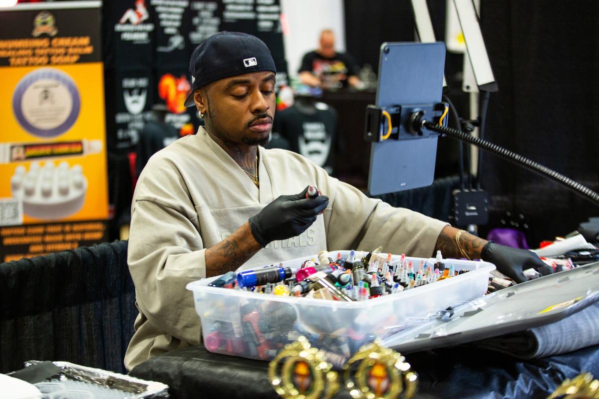 Dallas resident Kevin Laroy sifts through ink bottles during Fort Worth Tattoo Arts Festival on Friday, June 7, 2024, at the Fort Worth Convention Center. Laroy has been featured on various tattoo shows such as Ink master, Black Ink Crew, and How Far Is Tattoo Far on MTV.