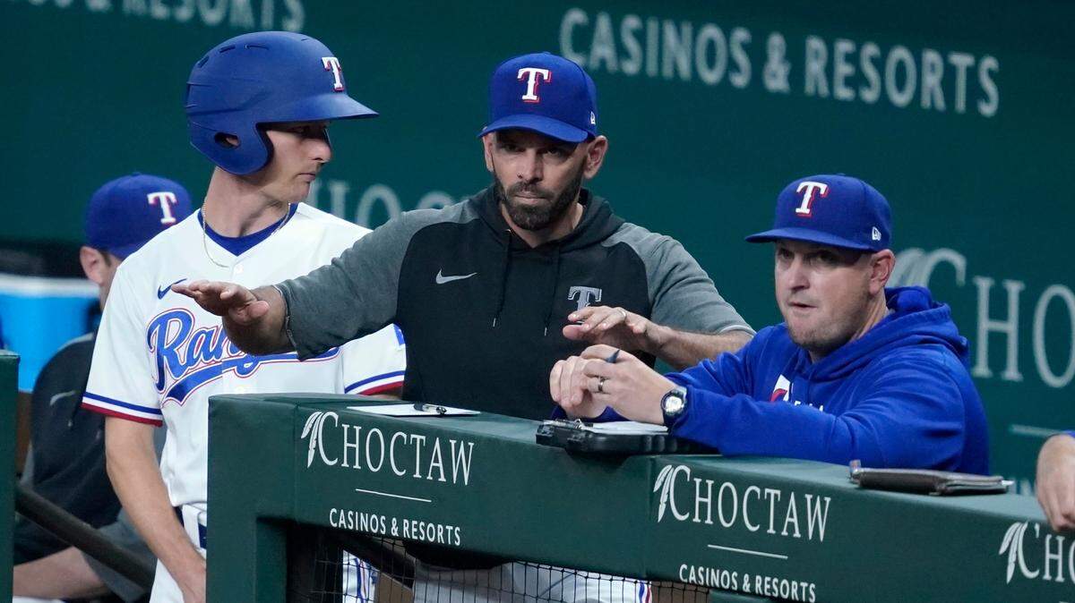 Texas Rangers manager Chris Woodward, center, said he wants to see more “fight” from his team after being swept and outscored by the Blue Jays 25-2.