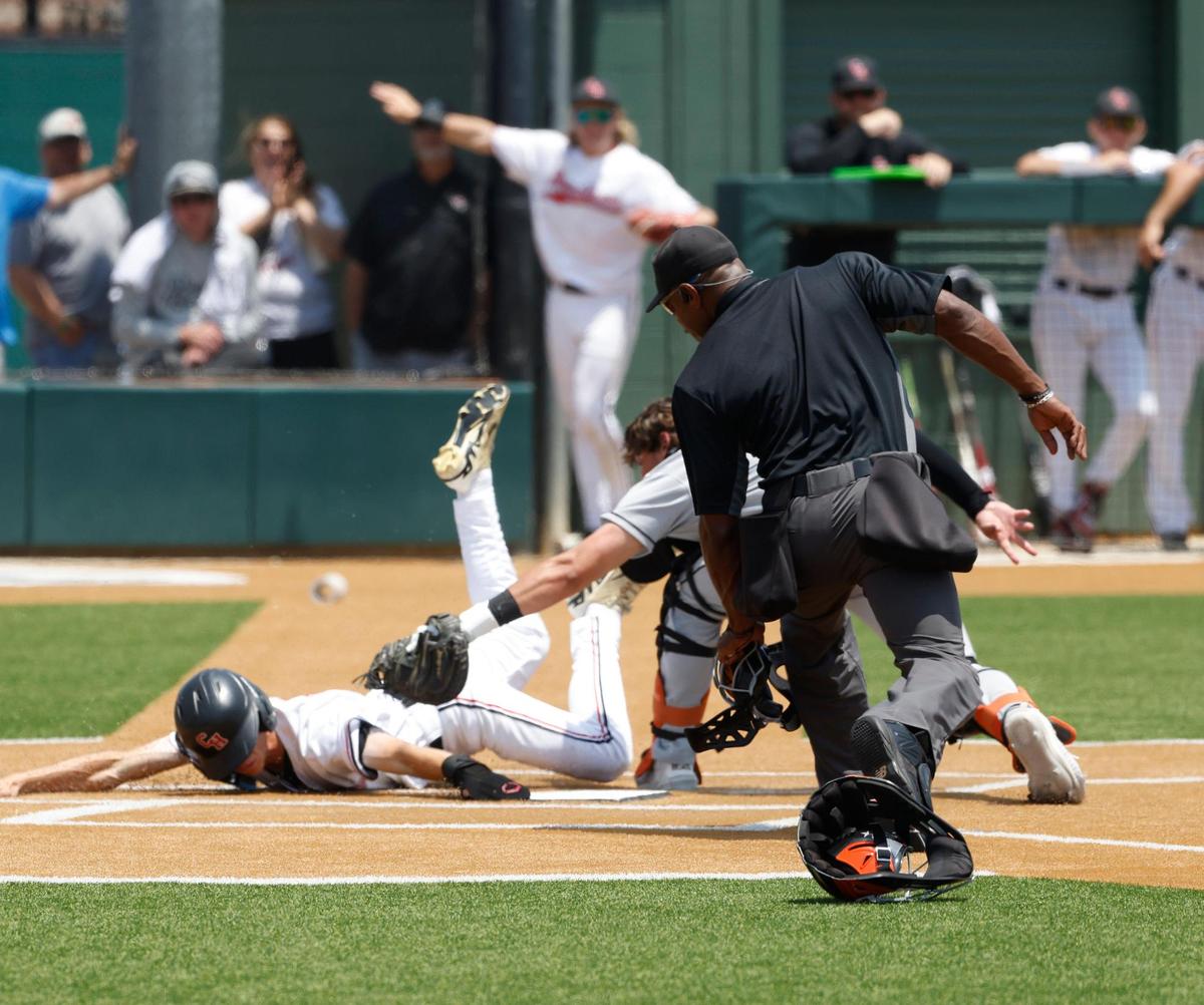 Colleyville Heritage outfielder Holden Abrahams (15) is ruled safe under the tag from Aledo catcher Brennon Evans (13) during the UIL baseball regional final 5A D1 playoff game at Hawk Baseball Field in North Richland Hills, Texas, Thursday, May 22, 2025.