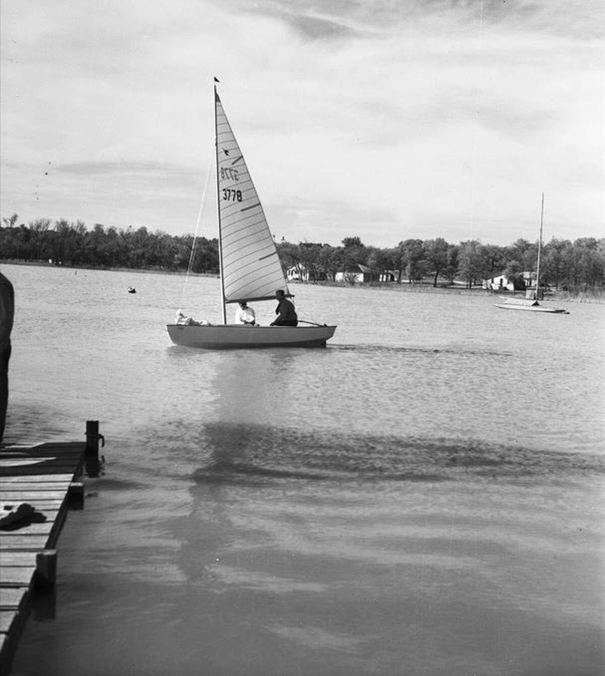 John Hayward, of Tulsa, Oklahoma, sailing on Eagle Mountain Lake with an unnamed passenger in the 1940s.