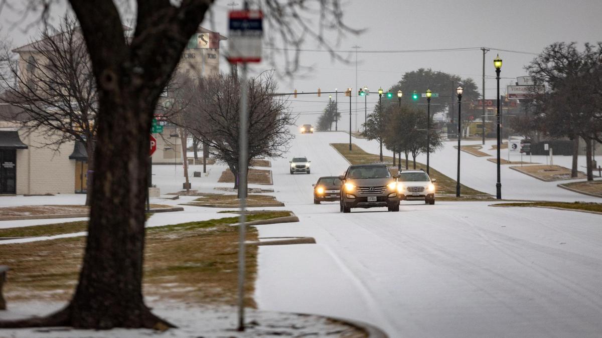 Cars drive through icy weather in Fort Worth on Tuesday, Jan. 31, 2023. Winter storm conditions have extended through Thursday morning as freezing rain continues.