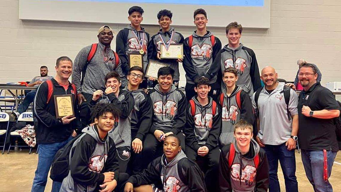 Arlington Martin boys celebrate the championship trophy at the 6A Region 1 meet on Saturday Feb. 15, 2020 in Haltom City.