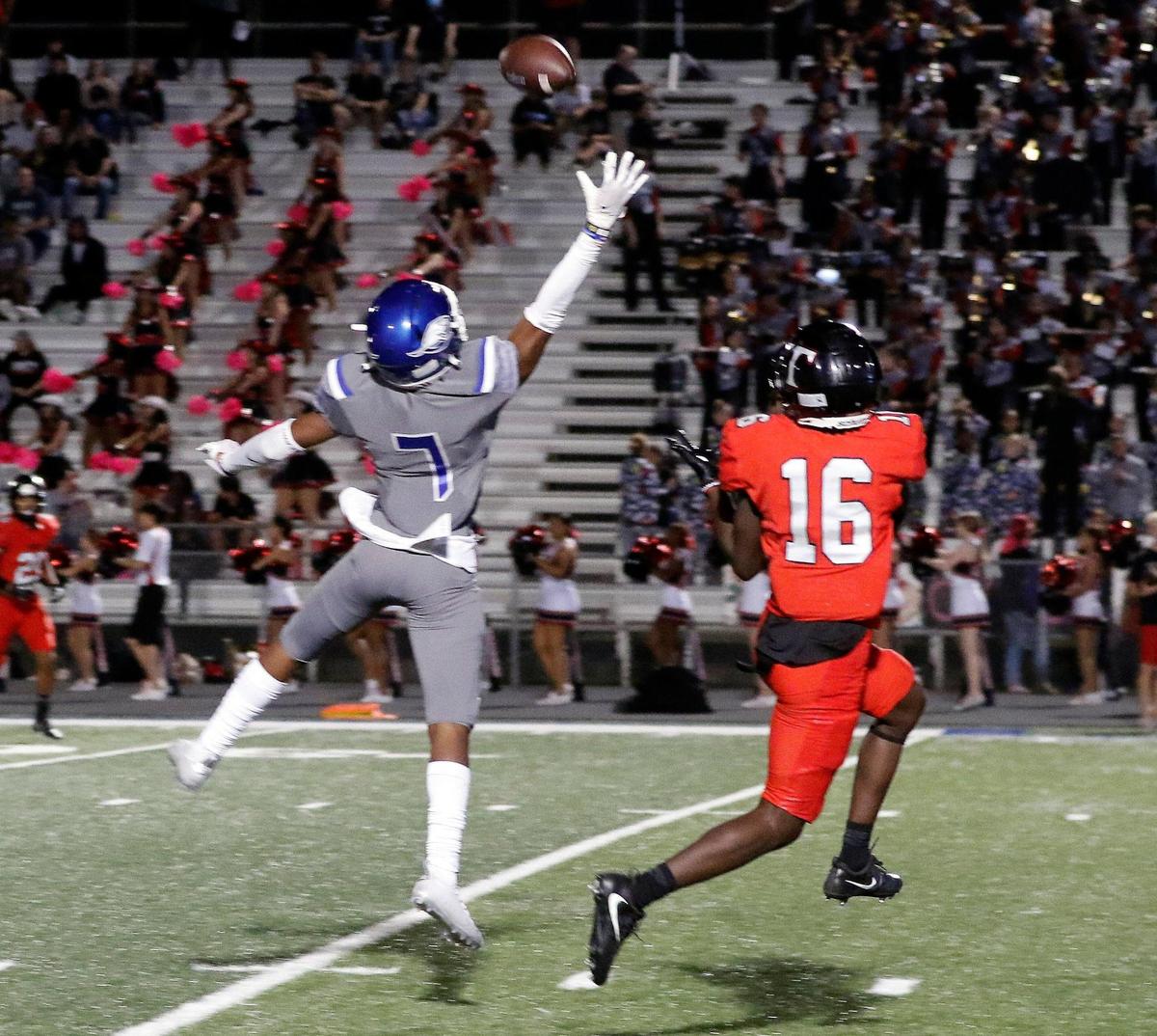 The ball, just over the fingertips of Weatherford wide receiver Melvin Polk (7) is intercepted by Trinity defensive back Ahmad Hassan (16) in a District 3-6A high school football game at Kangaroo Stadium in Weatherford, Texas, Friday Oct. 22, 2021. Trinity defeated Weatherford 49-21. (Special to the Star-Telegram Bob Booth)