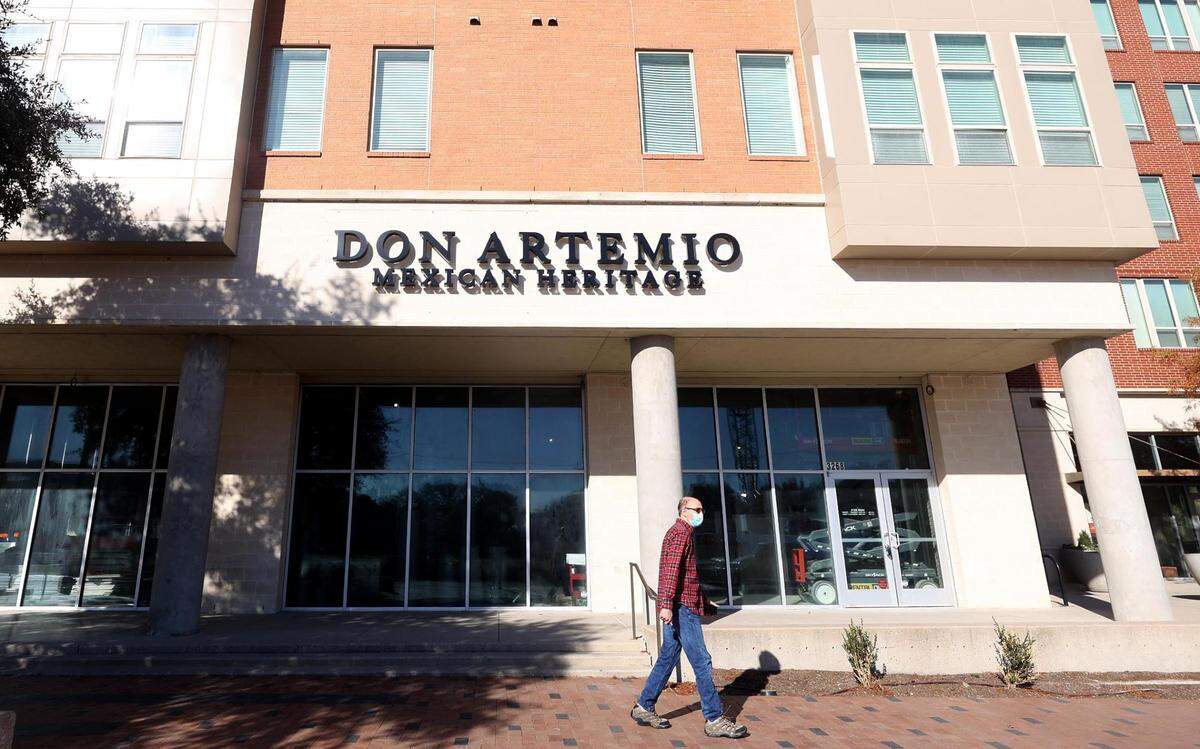 A pedestrian walks past the future location of Don Artemio as construction continues inside on Monday, December 13, 2021.