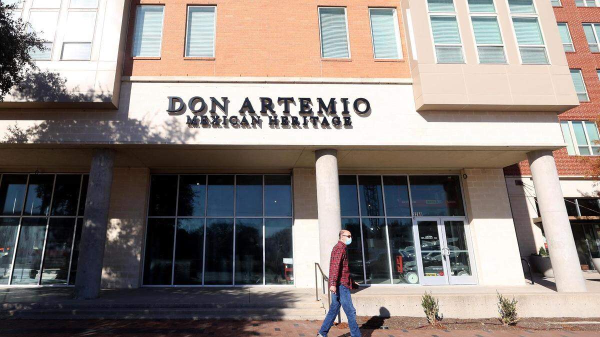 A pedestrian walks past Don Artemio.