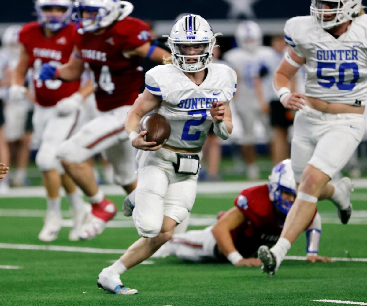 Gunter quarterback Walker Overman gains yards crossing the field during the first half of the UIL Conference 3A Division 2 state championship football game at AT&T Stadium in Arlington, Texas, Thursday, Dec. 14, 2023.