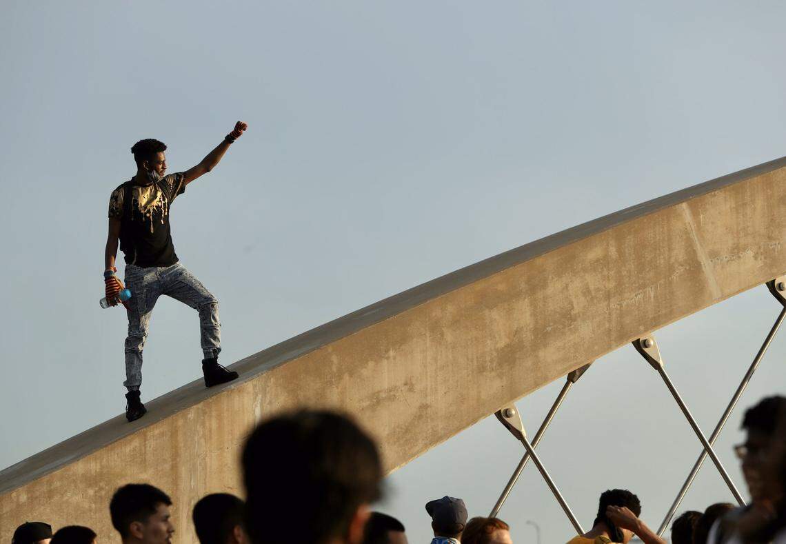 Hundreds of protesters who marched through downtown Fort Worth on Sunday night moved down West 7th Street, where they had an tense encounter with police on a bridge over the Trinity River.