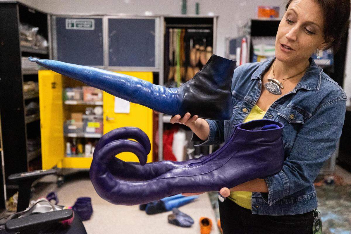 Janie Mallet, publicist, holds up a pair of shoes for Cirque de Soleil OVO on Thursday, Sept. 22, 2022, at Dickies Arena in Fort Worth. The show opens Thursday and runs through Sunday.