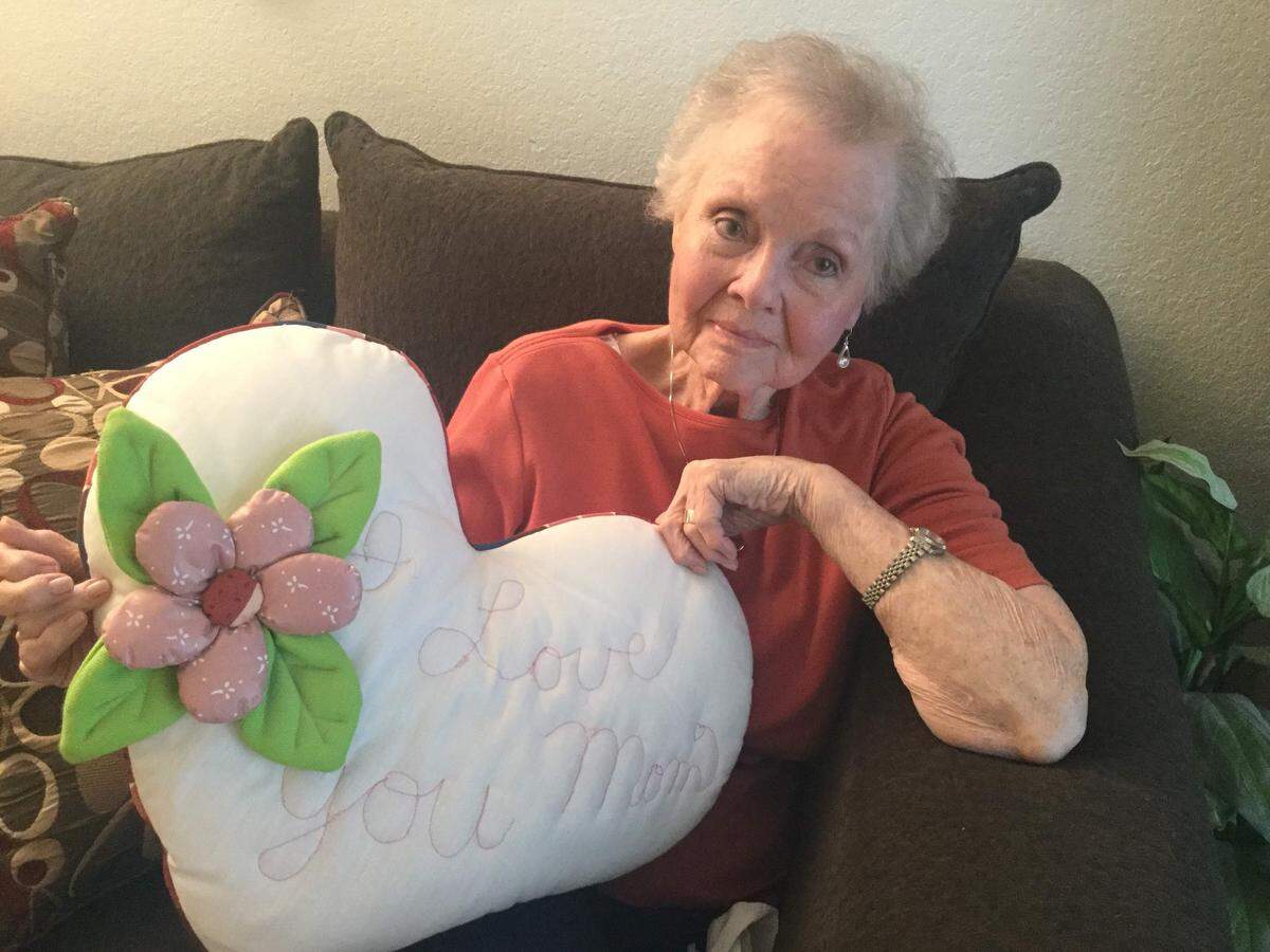 Dean McLaughlin holds a pillow her daughter, Dana Bowman, has sewn for her not long before the seamstress was murdered.