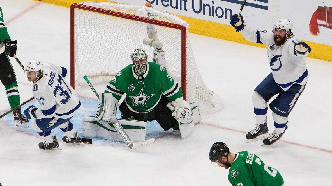 Tampa Bay Lightning left wing Yanni Gourde (37) and Pat Maroon (14) react to a goal by Kevin Shattenkirk against Dallas Stars goaltender Anton Khudobin (35) during overtime of Game 4 of the NHL hockey Stanley Cup Final, Friday, Sept. 25, 2020, in Edmonton, Alberta. (Jason Franson/The Canadian Press via AP)