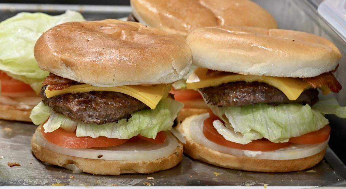 Burgers ready to be wrapped at Nation’s Giant Hamburgers in Modesto, Calif., Nov. 16, 2022.