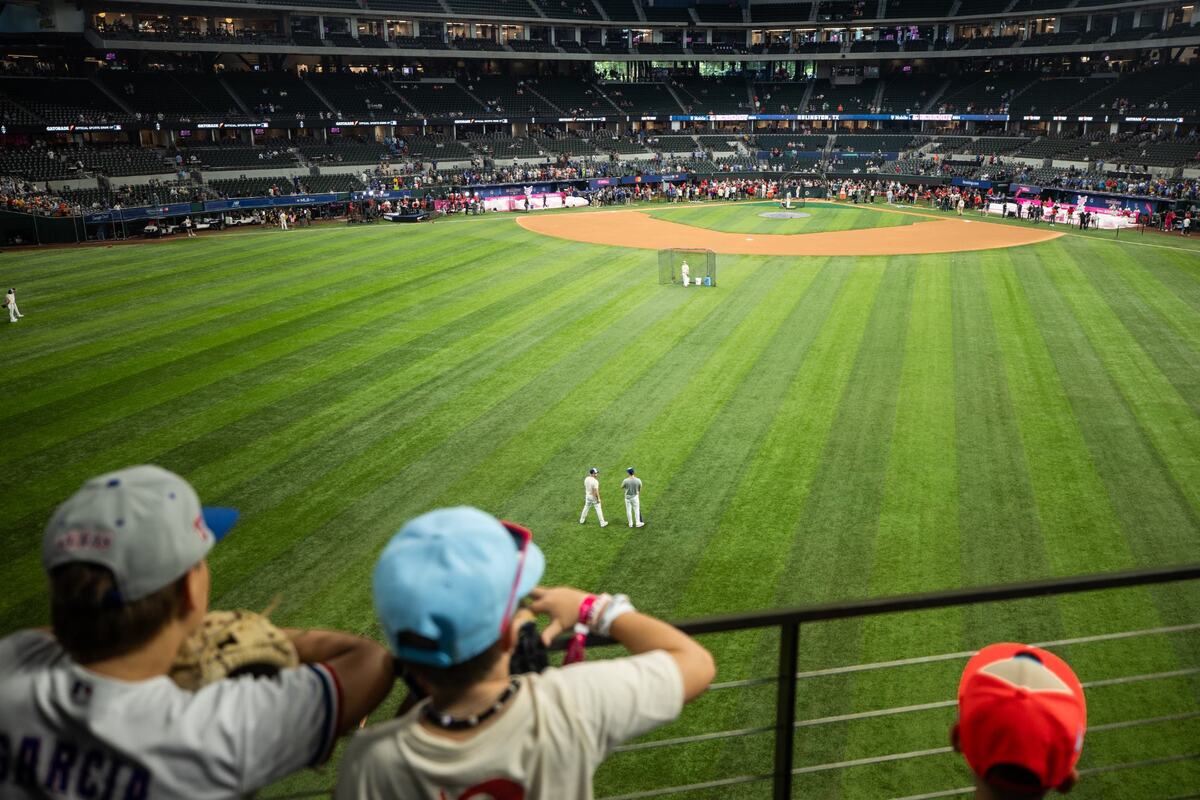 Bentley Myers, 11, left, and Ty Potter,10, center watches the players practice before the Home run derby on Monday, July 15 at Globe Life Field in Arlington. The Young fans bought baseball gloves to potentially catch the home runs hit by players.