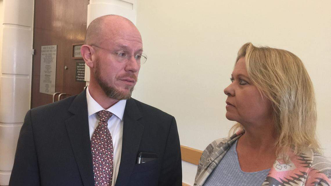 Clay Graham discusses case with Paula Smith on Wednesday in hallway at Tarrant County courthouse. Smith was accused of helping a violent sexual predator escape from a halfway house in 2015.
