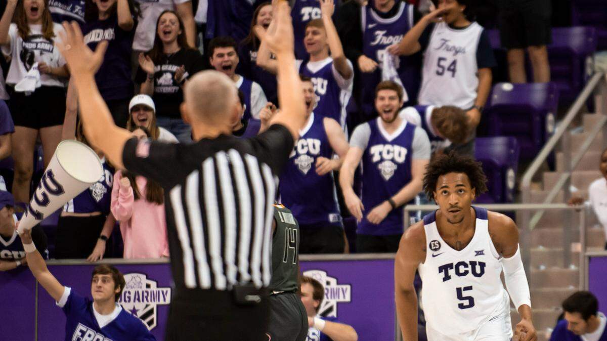 TCU fans celebrate after forward Chuck O’Bannon Jr. sank a 3-pointer in the first half of Tuesday’s game against Oklahoma State in Fort Worth. O’Bannon scored a team-high 19 points in the Horned Frogs’ 77-73 victory.