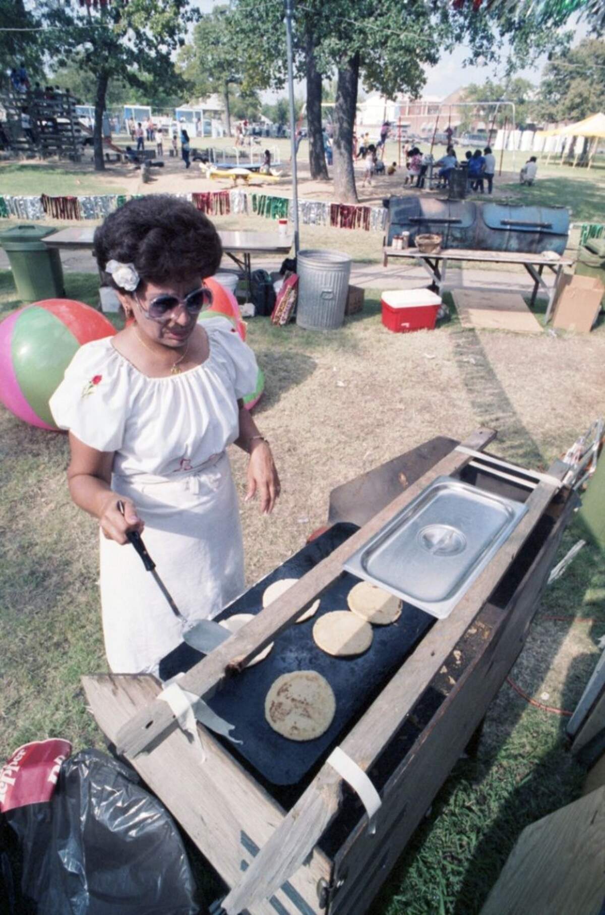 Sept. 13, 1986: A woman is seen flipping pupusas on a griddle during the Mexican Independence Day fiesta at Marine Park in Fort Worth.