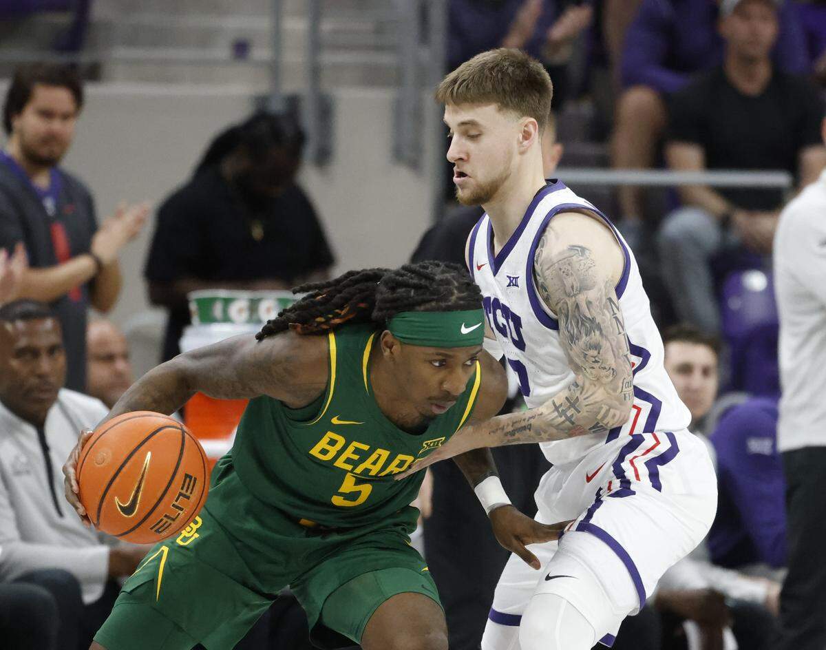 Baylor guard Obi Agbim (5) drives into TCU guard Brock Harding (2) during the first half of a NCAA basketball game between Baylor University and TCU at Schollmaier Arena in Fort Worth, Texas, Saturday Jan. 03, 2026