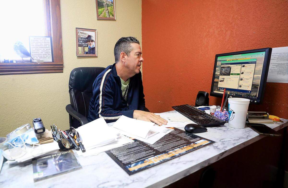 Wayne Harrison monitors an used auto auction from his office at Owl Own It Auto Sales. Harrison said the rise in vehicle prices has affected his business, which focuses on older vehicles at a lower cost, making it more difficult to sell cars to customers on a tight budget.