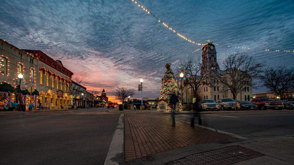 FILE -- Christmas lights shine bright on the Granbury Square with the historic Hood County Courthouse, right, and the Opera House, left. Photo taken Dec. 23, 2022.